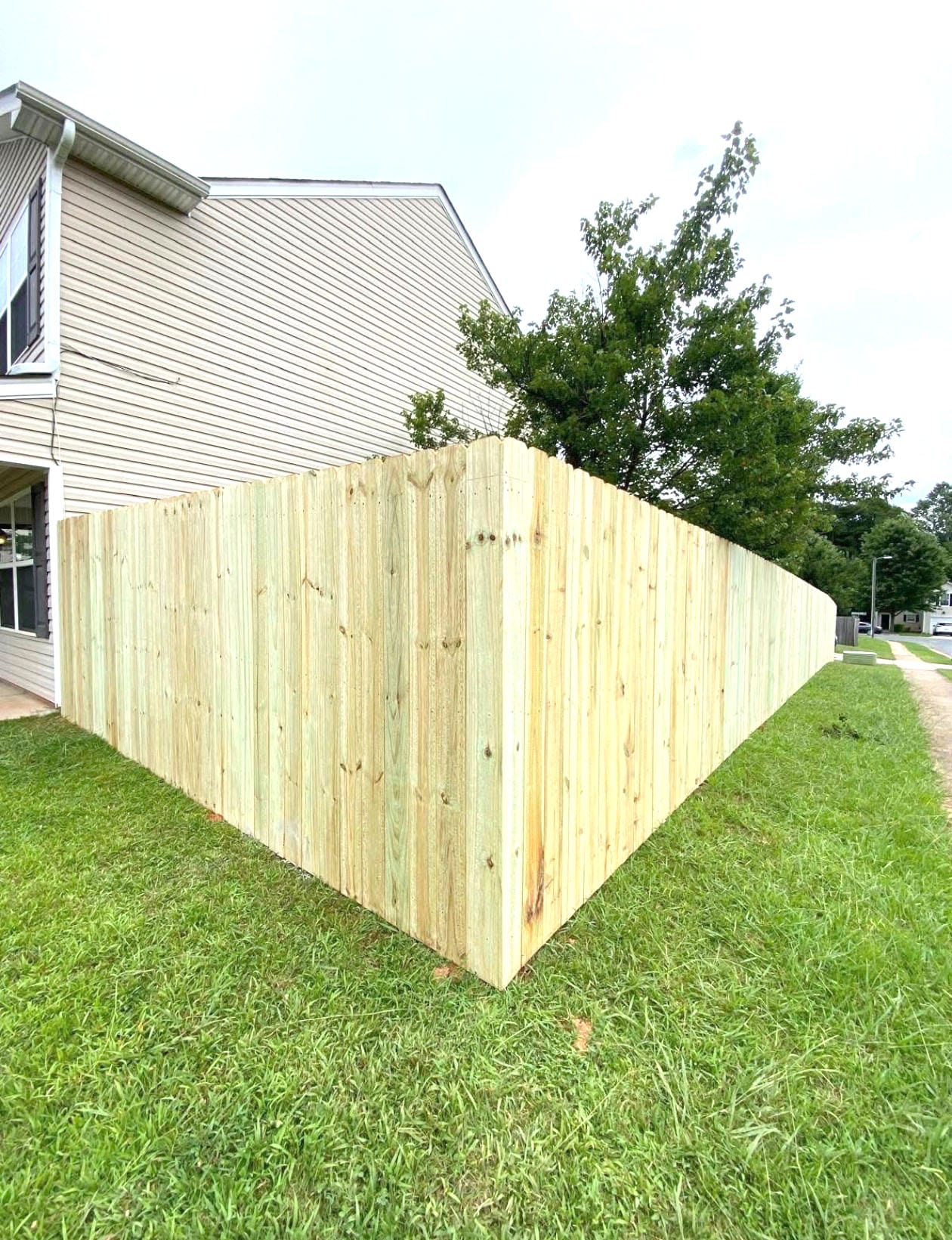 Wooden privacy fence built around a residential backyard